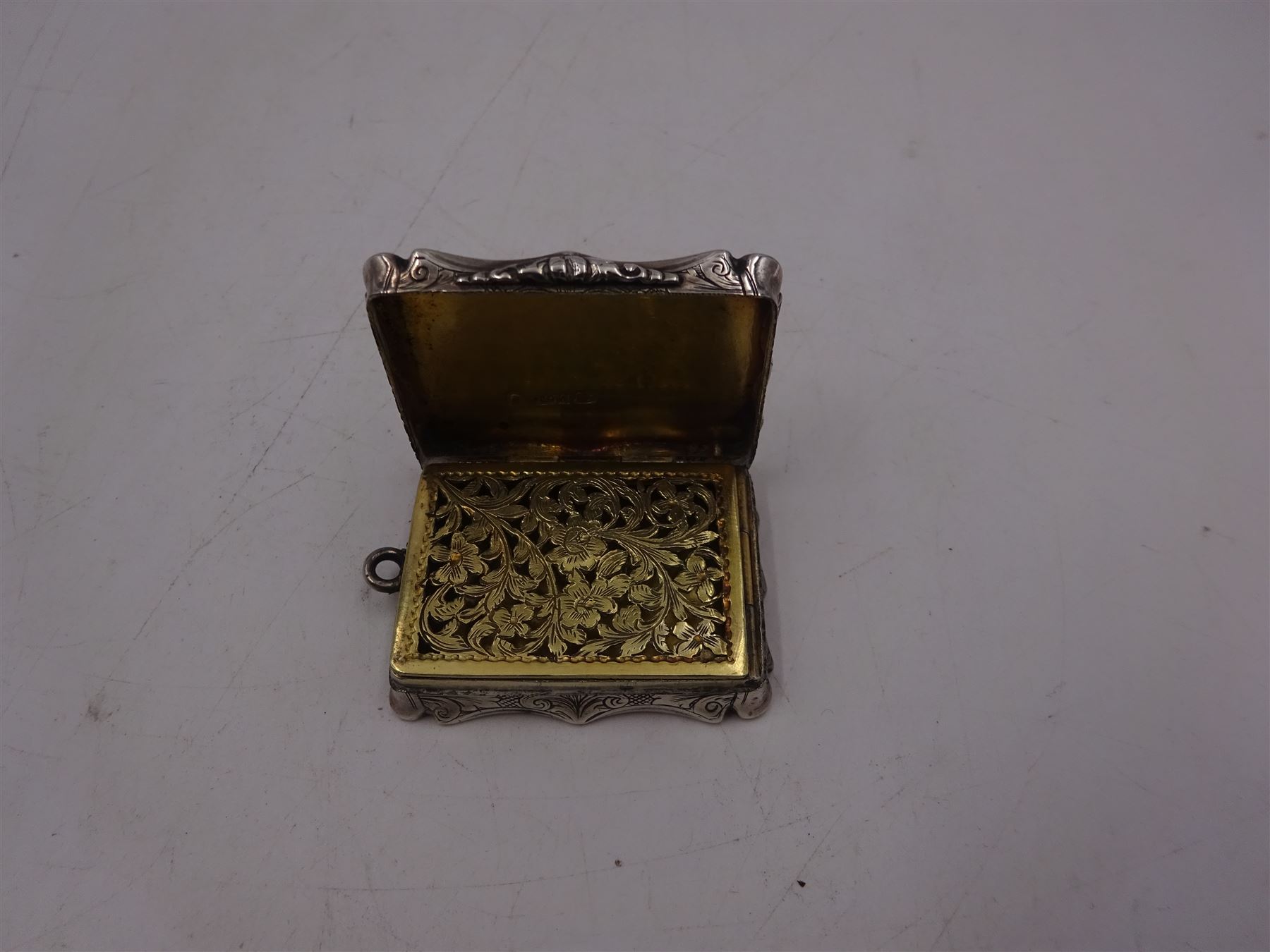 Victorian silver vinaigrette, with bright cut scrolling decoration and engraved name to hinged cover, the gilt interior with typical pierced cover, hallmarked Nathaniel Mills, Birmingham 1848, W4.2cm