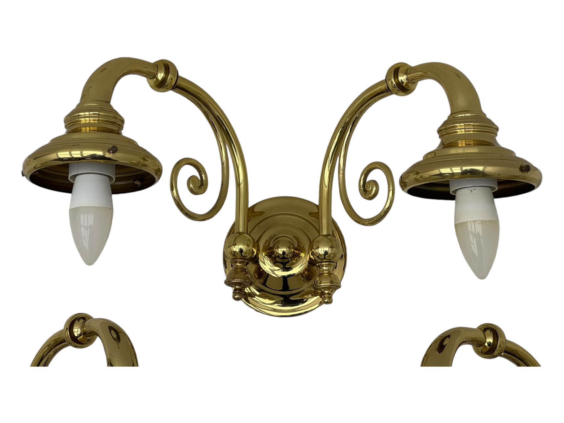 Two brass double-arm wall mounted lights, each with frosted glass globes and scrolled arms (W50cm, D26cm, H31cm); matching central double-arm light with candle-style fittings (W42cm, D24cm, H22cm)