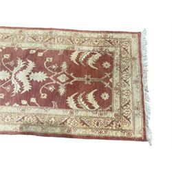 Persian Zeigler crimson ground runner rug, the field decorated with stylised foliate motifs and leafage, densely decorated guard band with floral and geometric patterns