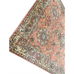 Persian design peach ground carpet, central floral medallion surrounded by scrolling foliage, decorated all over with stylised plant motifs, floral design repeating border