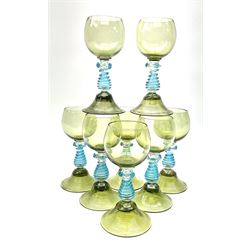 A set of eight German green glass hock glasses, with trailed spiral and prunt detail to the baluster stems, upon domed feet, H15.5cm.