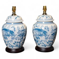 Pair of table lamps of baluster form, decorated with exotic birds up fruiting trees, on ha...