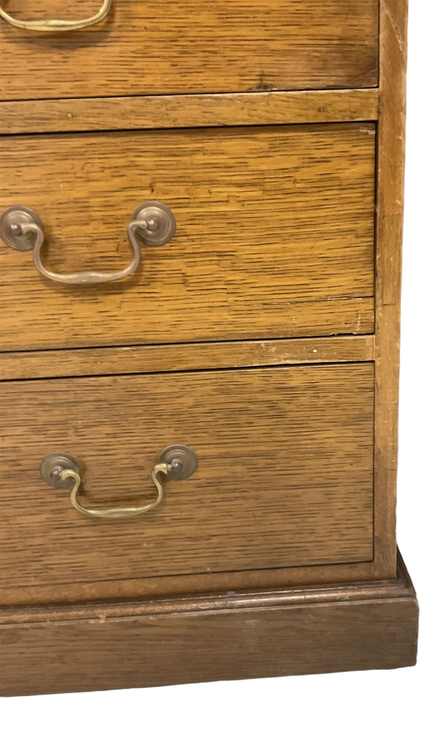 Late 19th century twin pedestal oak partner's desk, rectangular top with inset green leather writing surface, fitted with nine graduating drawers to each side, the rear drawers enclosed by panelled cupboards