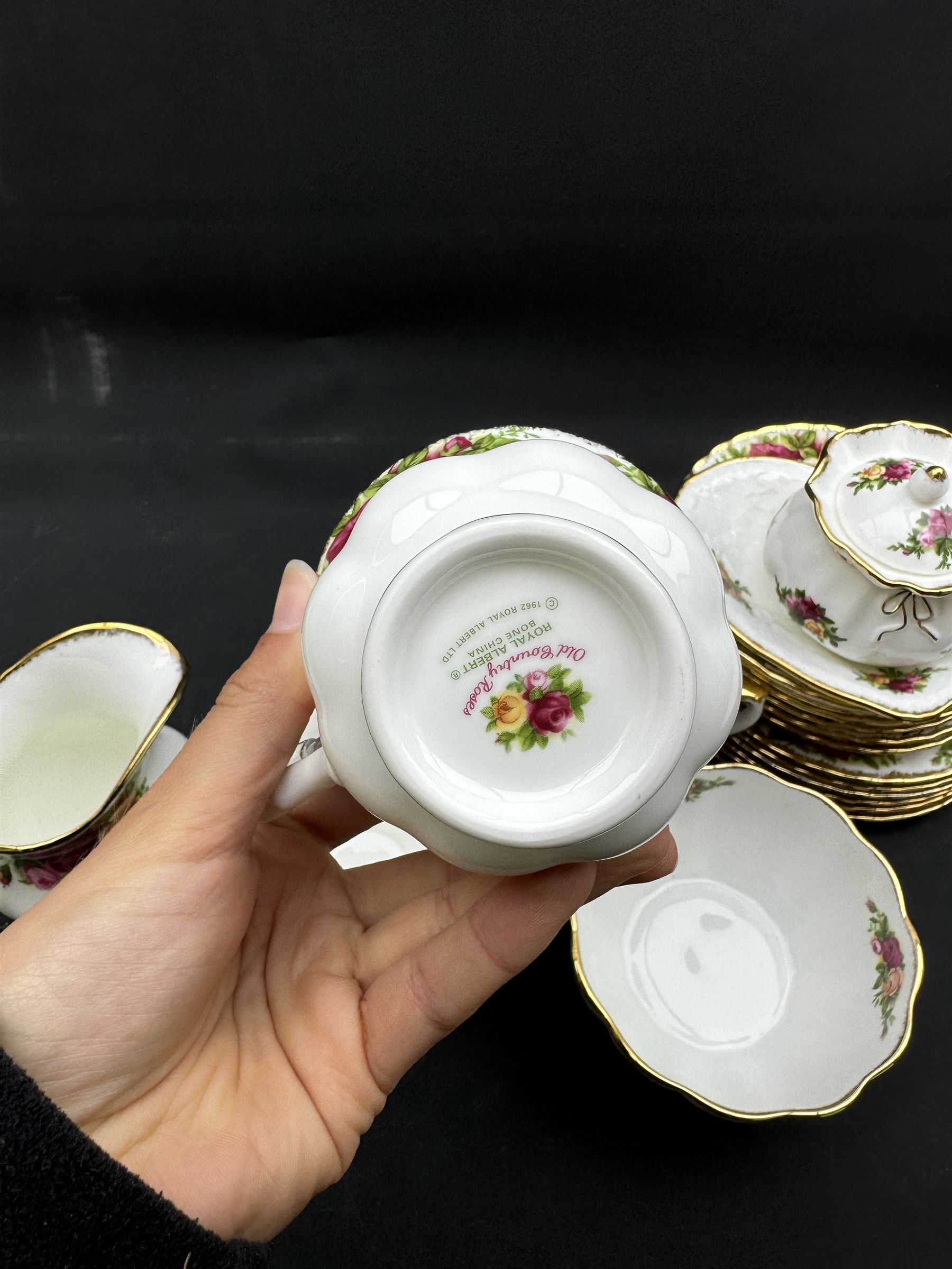 Royal Albert Old Country Roses tea service for six, comprising teapot, milk jug, open sucrier, cups and saucers, dessert plates, two trinket dishes covered jar and clock