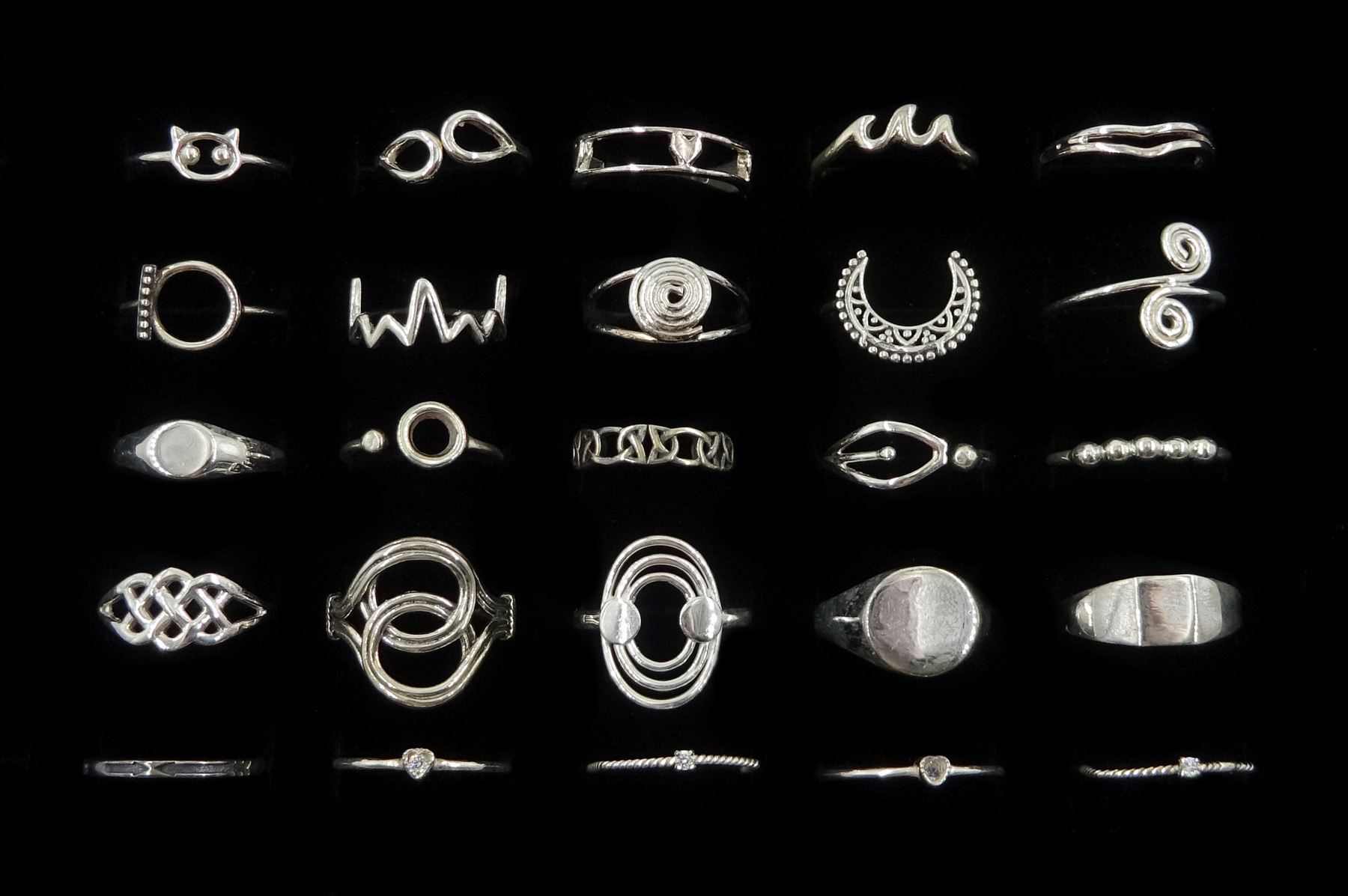 Twenty-five silver rings including crescent, Celtic design, swirl and bead