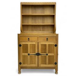 Mouseman - oak dresser, penny moulded cresting rail over two shelves supported by shaped e...