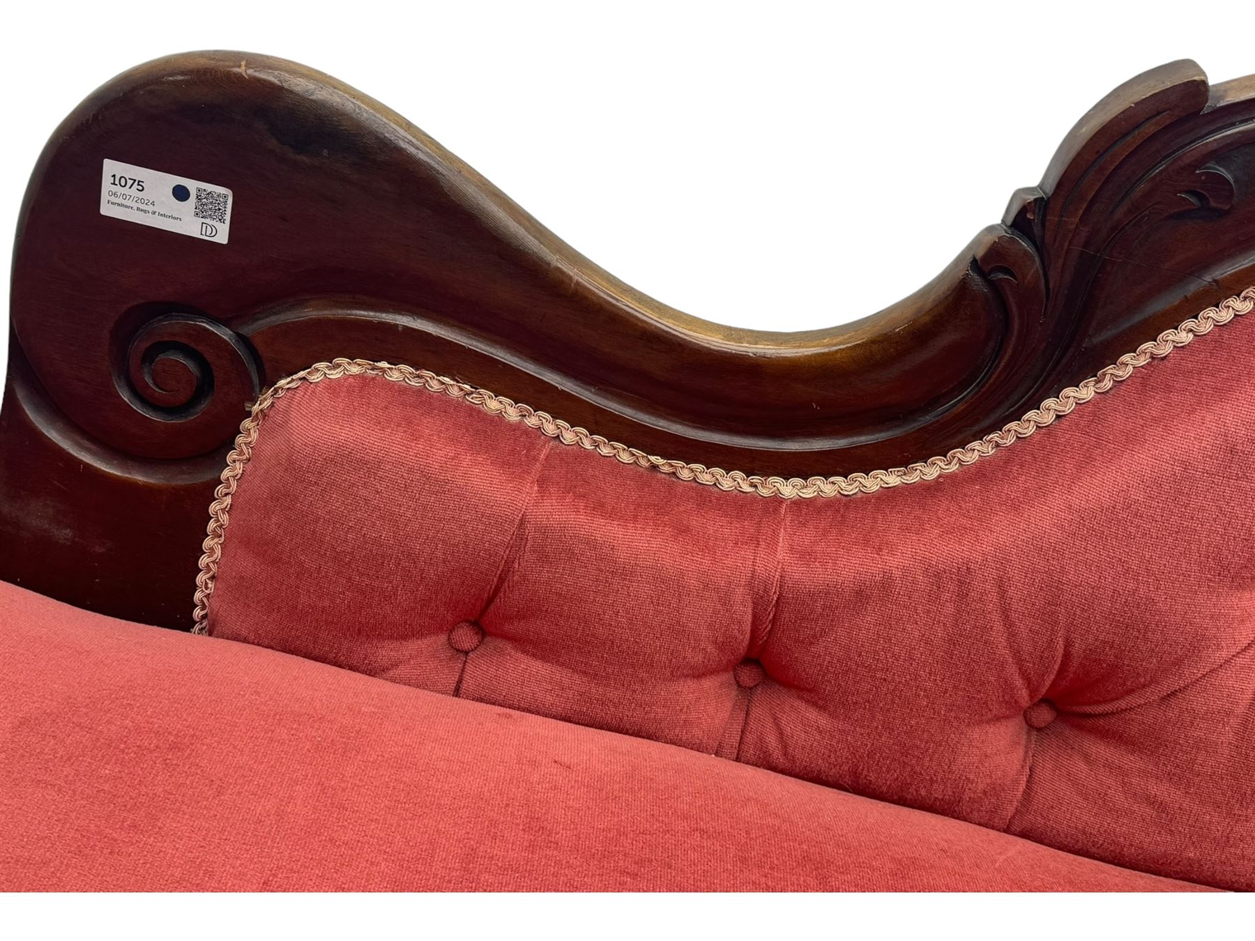 Victorian mahogany framed chaise longue, upholstered in pink velvet, the scrolled back with button-tufting, on turned feet