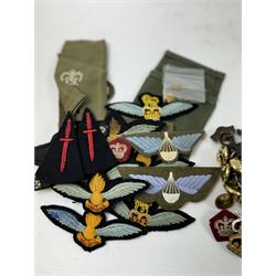 Various cloth and metal military badges including cap and collar badges, rank crowns and stars, staybrite button etc