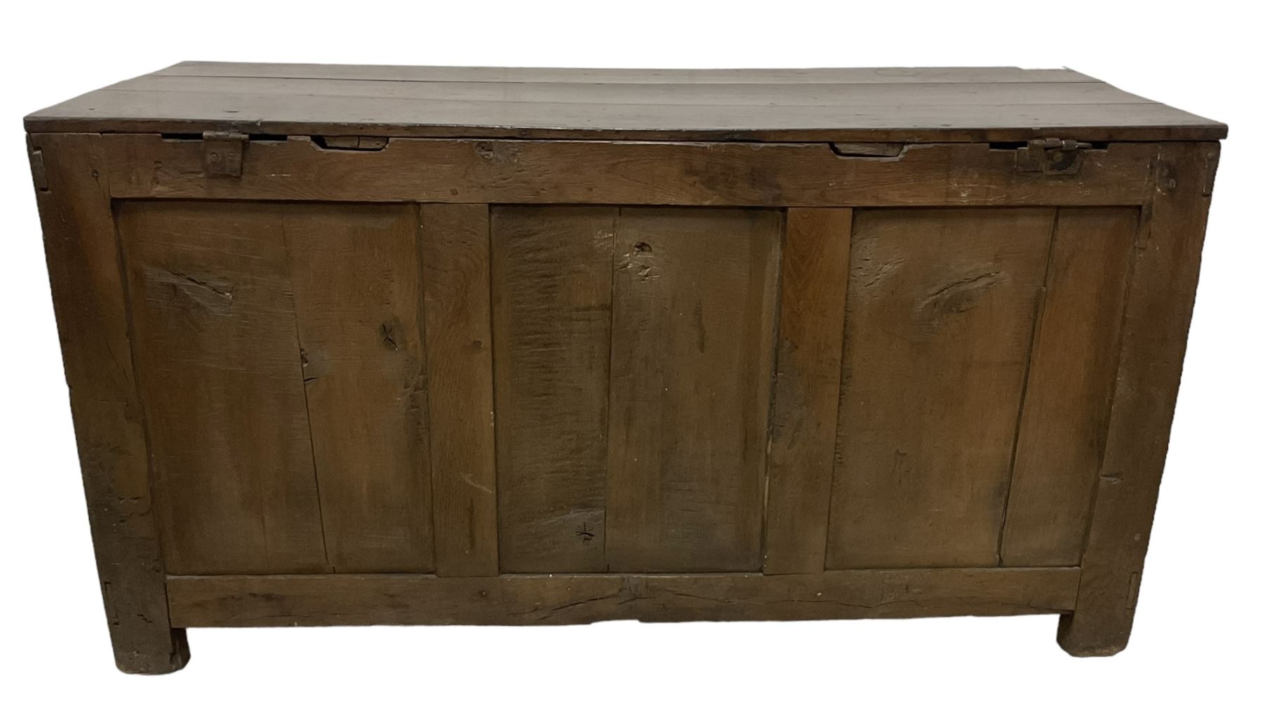 Large 18th century oak coffer or blanket box, hinged lid over triple panelled front, panelled back and sides, on stile supports 