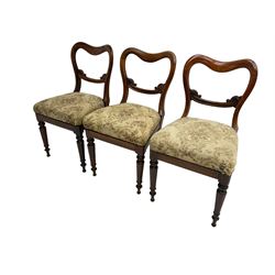 Set of six Victorian rosewood shaped balloon back dining chairs, C-scrolled middle rail carved with foliage, upholstered drop-on seats, on turned front supports