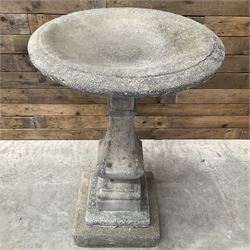 Cast stone garden bird bath, circular dished top, raised on square tapering column, on stepped base with separate mounting plinth