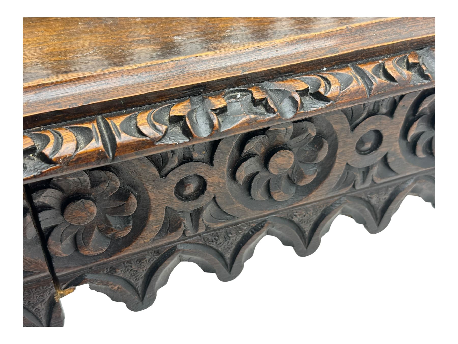 Victorian Gothic revival style carved oak console table, rectangular top with carved edge and raised back gallery, over deeply carved apron with floral and foliate motifs and central drawer, barley twist front supports and plain rear supports united by shaped stretchers, on front bun feet