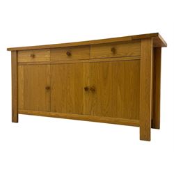 Contemporary oak sideboard, rectangular top with central contrasting plank, over three frieze drawers and three cupboards with enclosed shelving, on rectangular stile supports