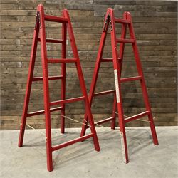 Pair of vintage red painted A frame trestles, with original A W Oates Painter signage