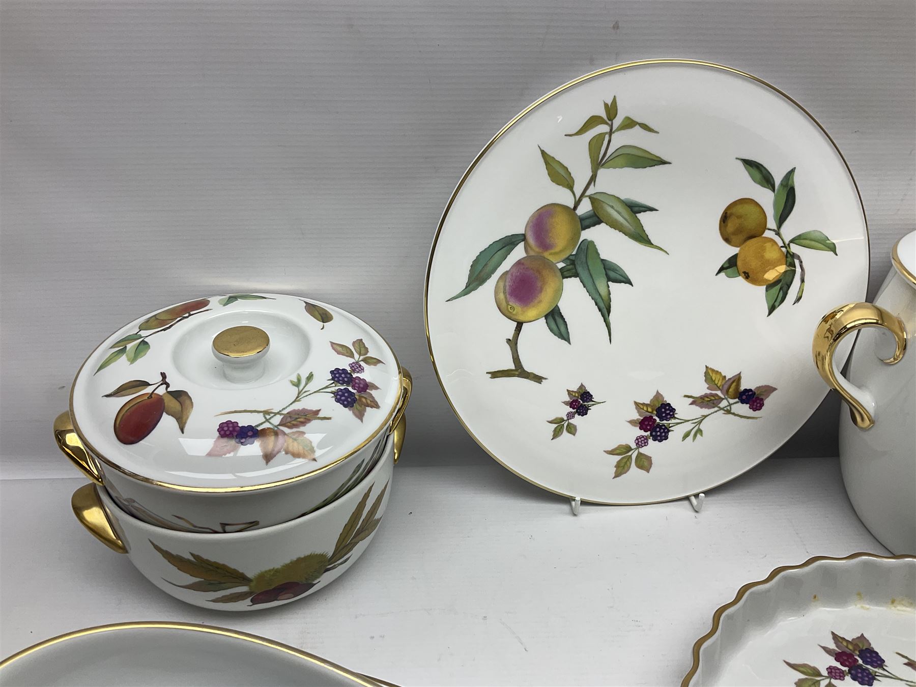 Royal Worcester Evesham pattern, including covered pot de cremes, twin handle tureen, serving dishes, flan dishes, side plates etc  