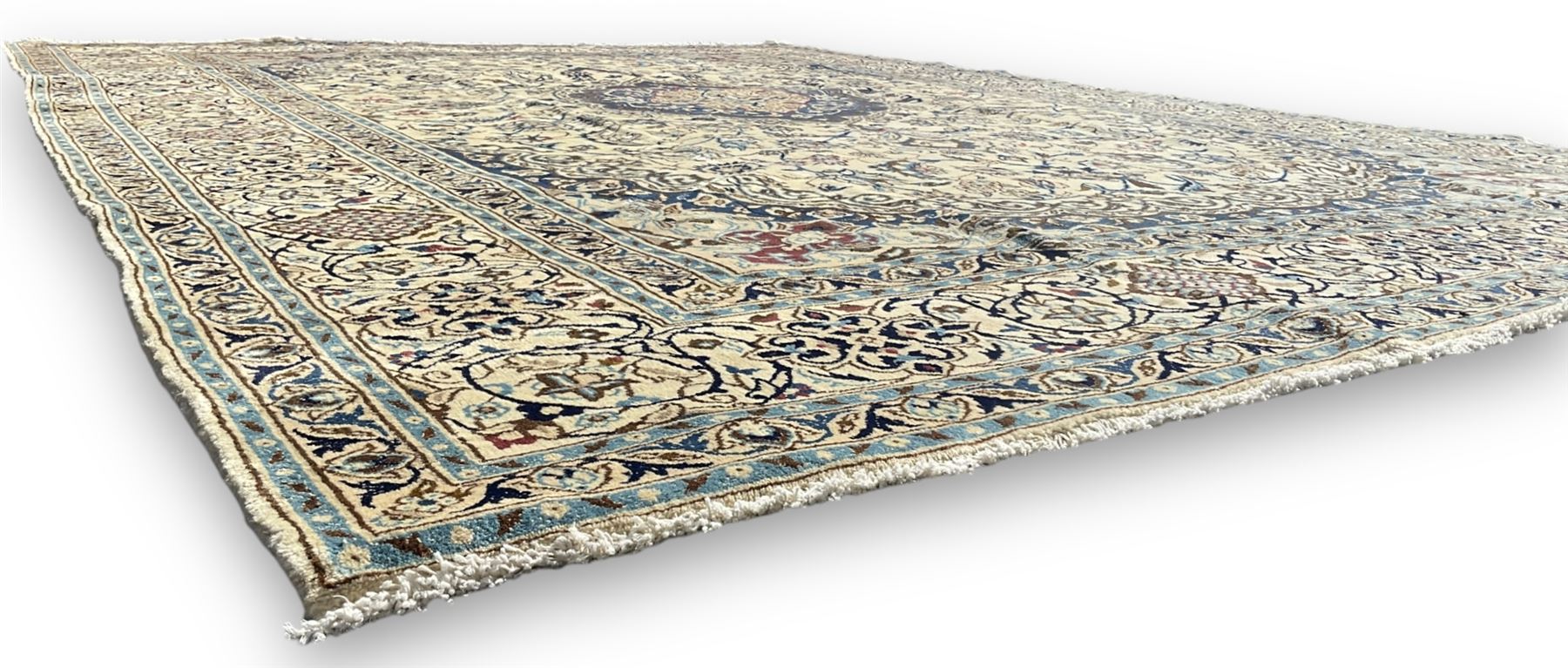 Persian Nain ivory ground carpet, central indigo medallion, the busy floral field decorated with scrolling vines and flower heads in shades of blue, beige, and red, wide guarded border with repeating palmettes and foliate motifs