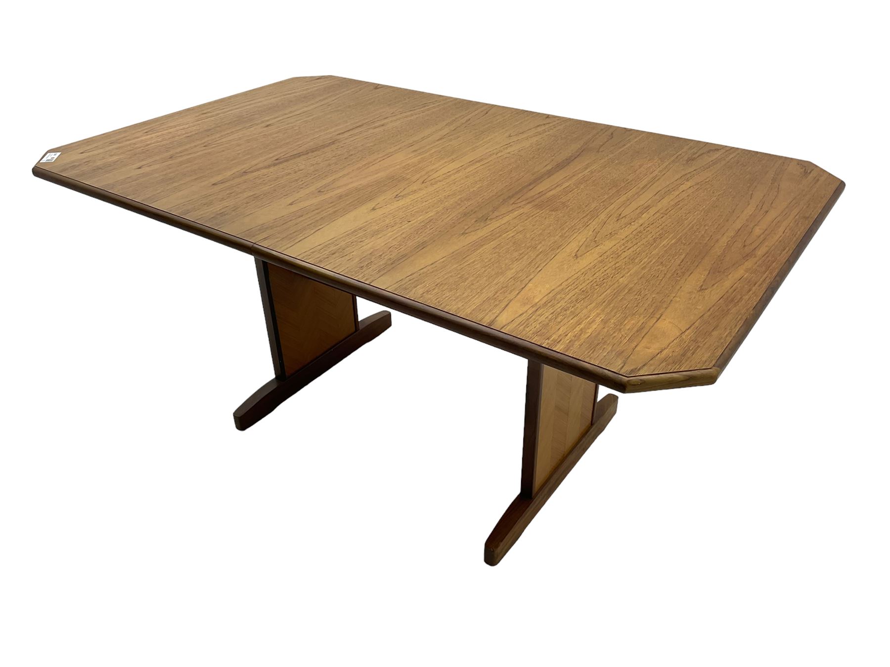 G-Plan -  1970s teak extending dining table, pull-out extending action with fold-out leaf, rectangular end supports on sledge feet united by stretcher (100cm x 160cm - 205cm, H73cm); set of six dining chairs, chevron-patterned backrests upholstered with floral patterned fabric, on tapered legs, H89cm