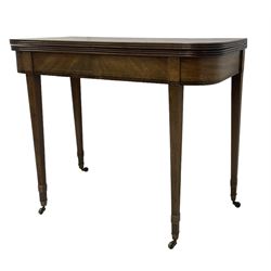 19th century mahogany tea table, fold-over top with reeded edge over inlaid frieze, on double gate-leg action square tapering supports, with brass castors