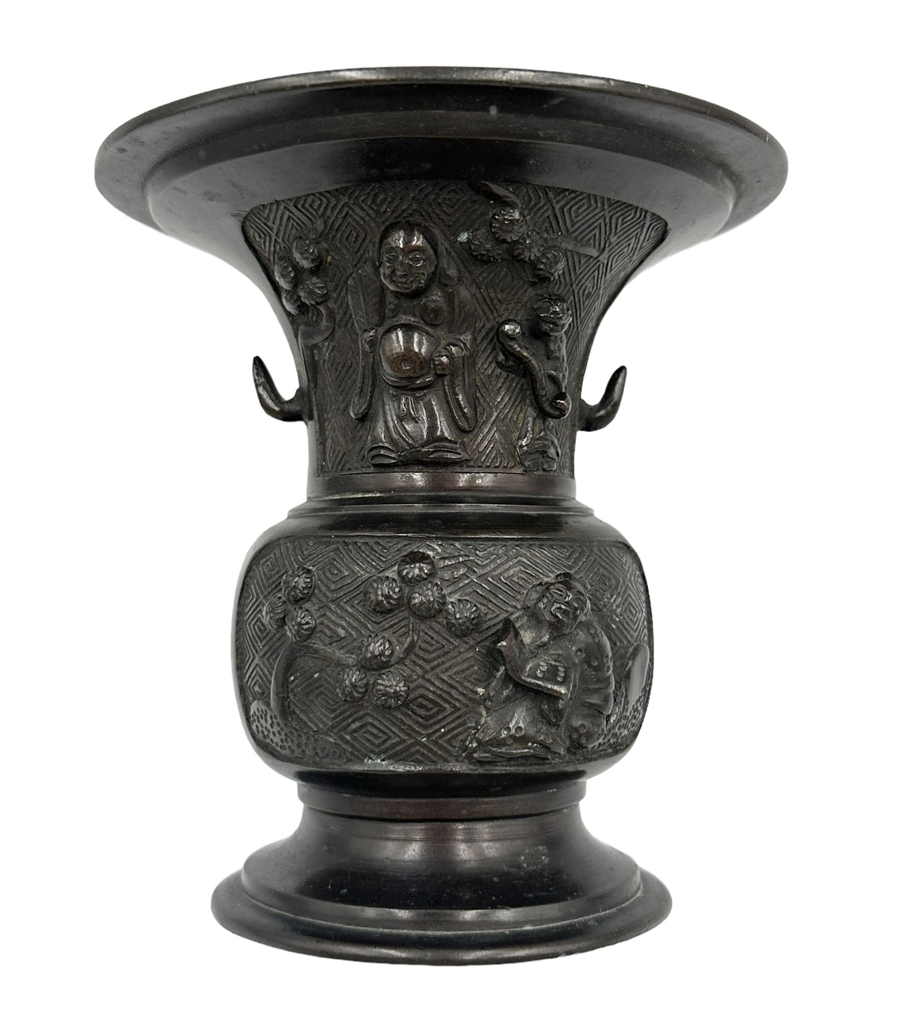 Chinese bronze gu vase decorated with a raised pattern of flowering branches, figures holding book, scrolls and fan on a circular foot H13cm