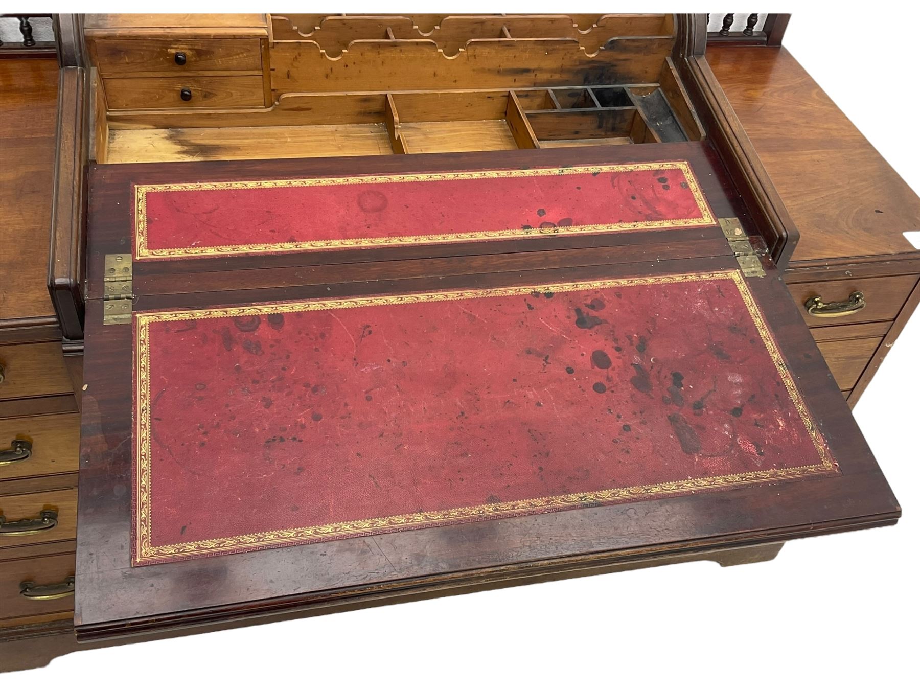 Victorian walnut clerk's desk, raised central section with tambour roll over hinged top, the interior fitted with leather inset writing surfaces, small drawers, document divisions and pen and ink stand, central drawer over double panelled cupboard, flanked by two banks of four graduating drawers, on bracket feet 