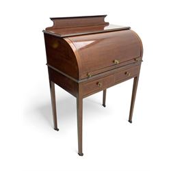 Edwardian inlaid mahogany roll-top desk, cylindrical lid enclosing fitted interior with pigeonholes, drawers and retractable writing surface, over two drawers with brass pull handles, on tapered supports with brass and ceramic castors