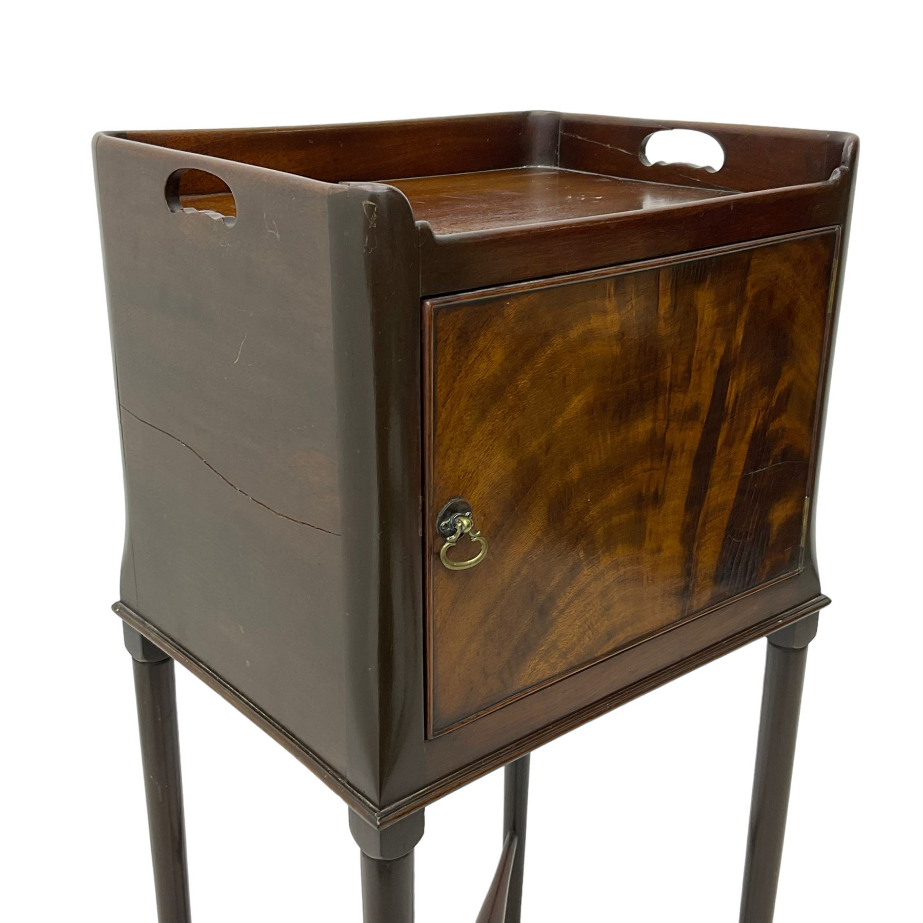 20th century Georgian design mahogany bedside pot cupboard, pierced tray top, enclosed by single figured door, on cabriole supports united by turned X-framed stretchers 