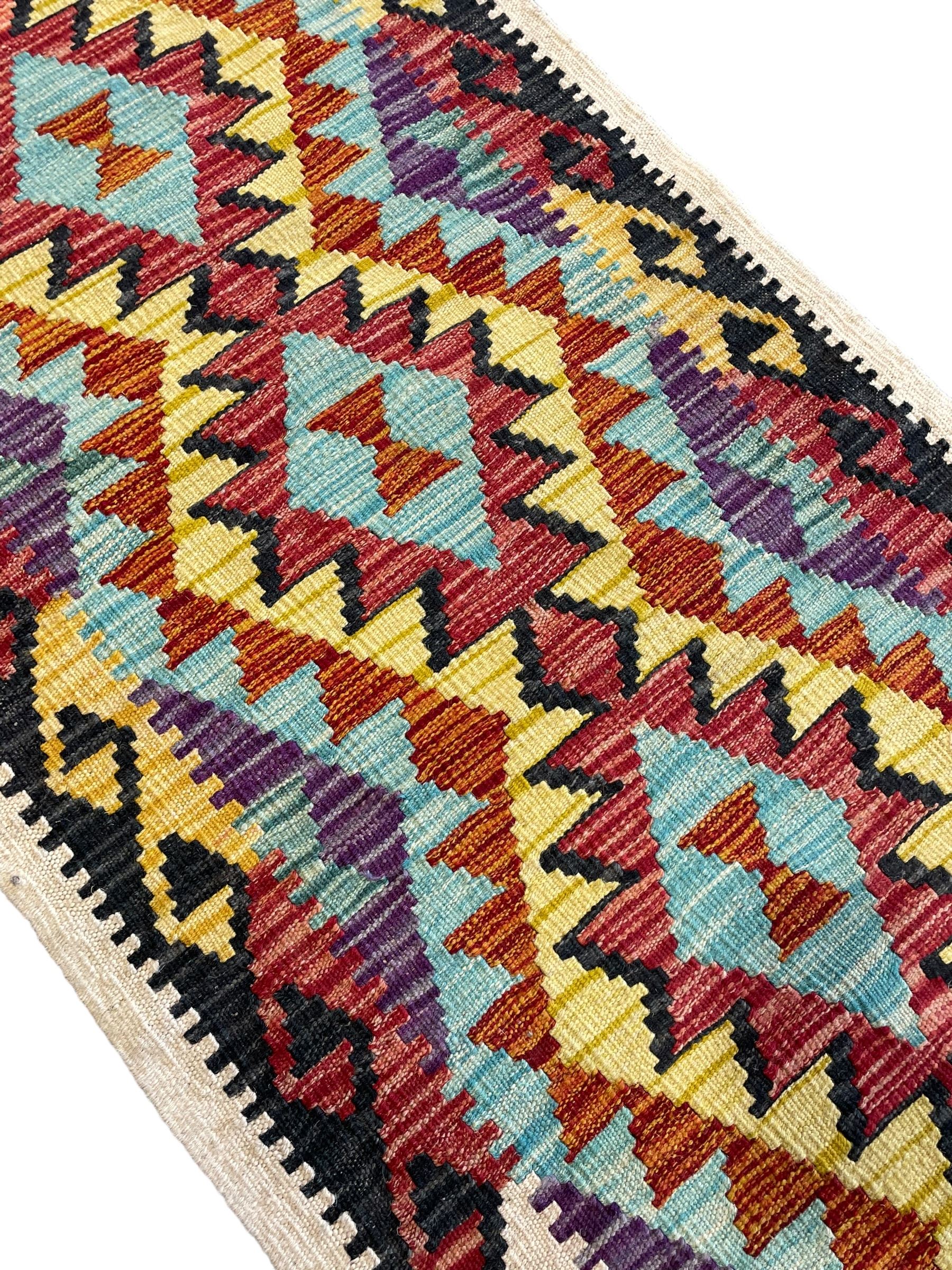 Chobi Kilim ivory ground runner rug, the field decorated with four multi-coloured lozenges, each with central geometric decoration, within concentric lozenges, enclosed by hooked border