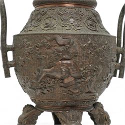 Large 19th century Japanese bronze koro, the ovoid body decorated in relief with phoenix and kylin amidst clouds, with two elongated loop handles and chrysanthemum finial, on four tall mask and tongue feet, impressed seal mark beneath, H44cm x W27cm 