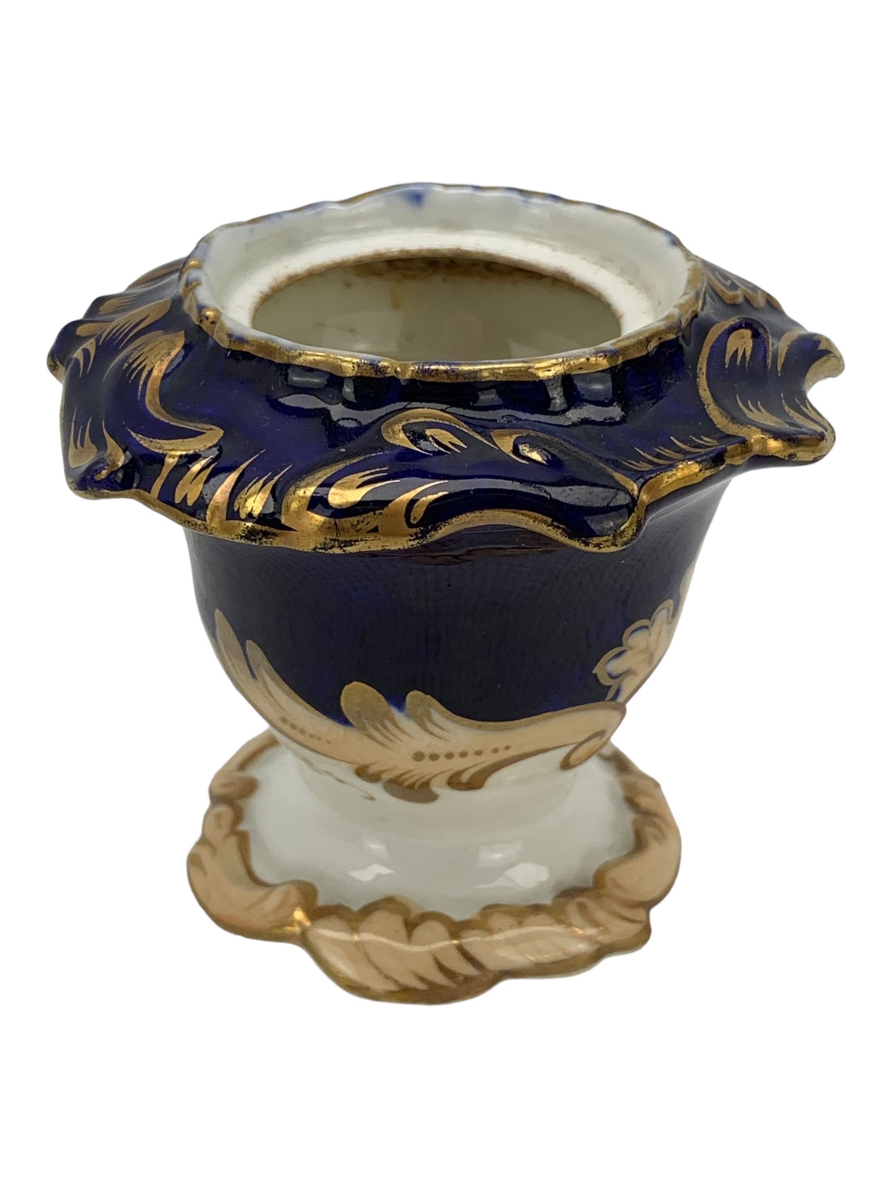 19th century porcelain inkstand, the oblong twin handled base centrally painted with a floral bouquet, flanked by two footed inkwells and covers, with rococo-inspired acanthus moulded borders and handles, pattern no. 2/3339, L26.5cm 