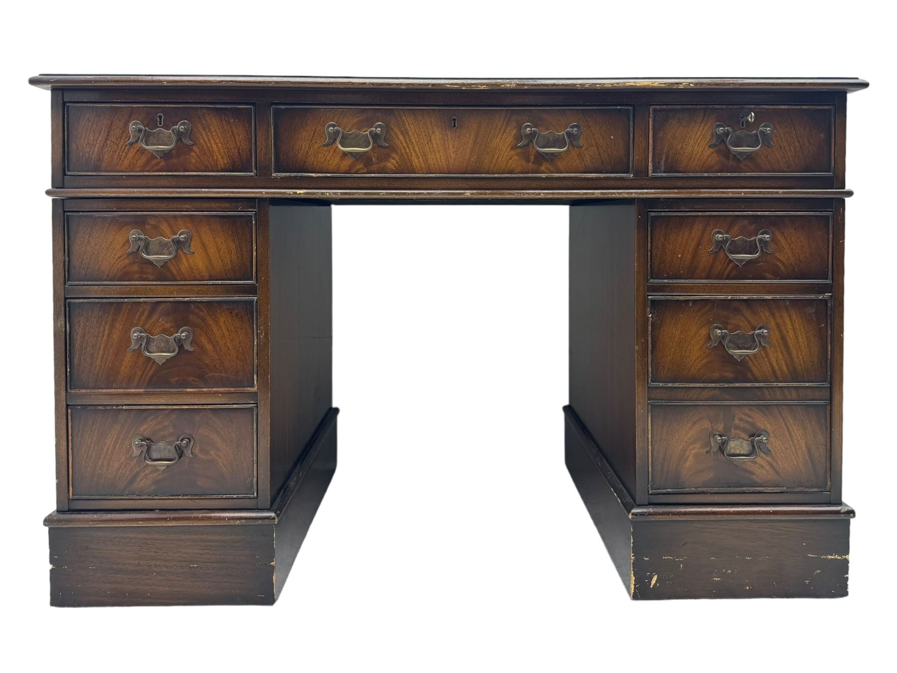 20th century mahogany twin pedestal desk, moulded rectangular top with red leather inset with gilt tooled border, central drawer over kneehole flanked by two banks of four graduating cockbeaded drawers, on plinth base