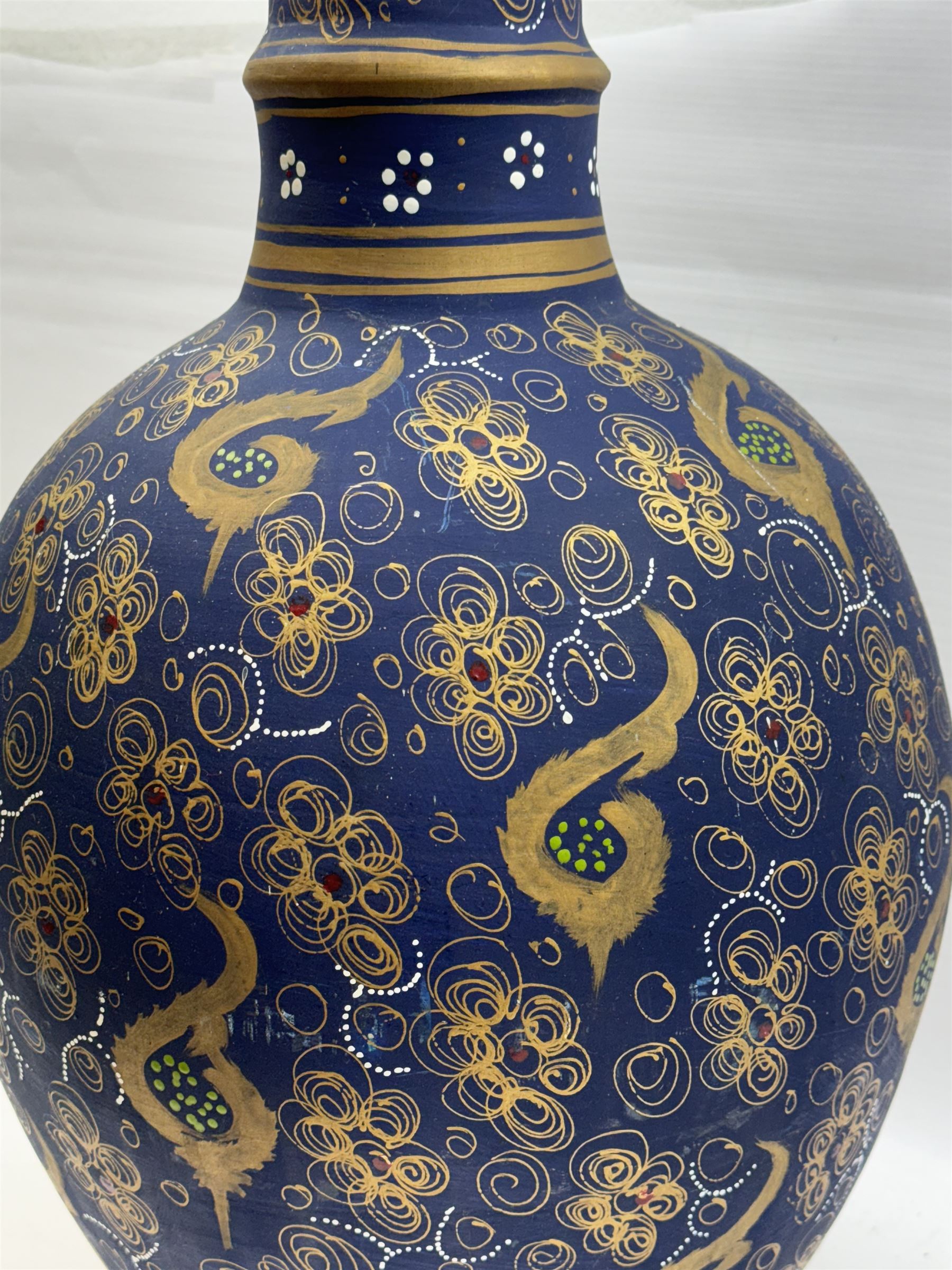 Large and unusual terracotta floor vase, of ovoid form with tall flared neck with frilled rim, decorated with stylised foliate motifs in gilt upon a dark blue ground, H89cm