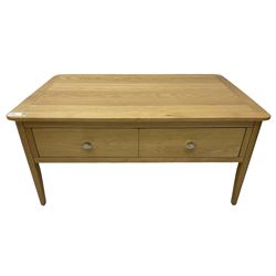 Contemporary light oak rectangular coffee table, fitted with single drawer disguised as two drawers to each side, on tapering supports