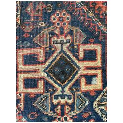 Persian Hamadan red and indigo ground rug, the central pole medallion decorated with geometric motifs, guarded border decorated with stylised plant motifs 