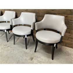 Four ebonised framed tub shaped armchairs, upholstered in grey fabric