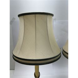 Pair of brass Corinthian column table lamps, each with cream lampshades with green piping, including shade H54cm