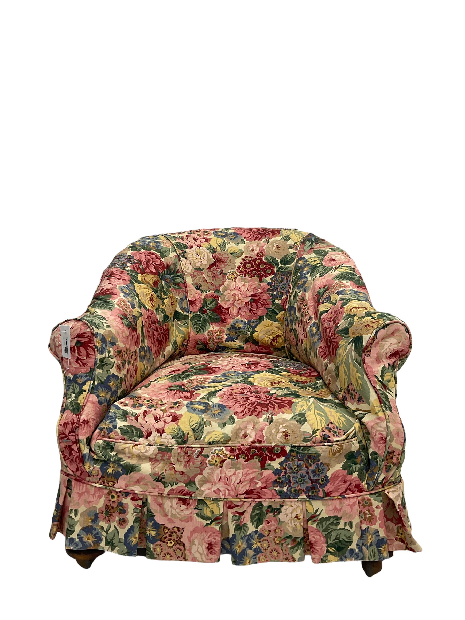 Victorian low tub shaped armchair, beech framed with compressed bun feet, loose floral fabric