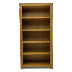 Light oak open bookcase fitted with four shelves 