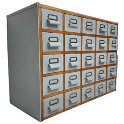 Mid-20th century multi-drawer chest or filing cabinet, fitted with twenty-five small drawers with wooden handles and metal label holders, in light blue paint finish 