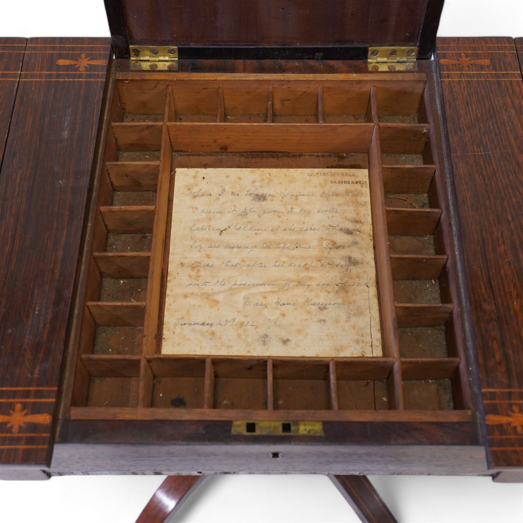 Victorian inlaid rosewood work or sewing table, the rectangular drop-leaf top with canted corners and inlaid with geometric banding, the hinged lid opening to reveal a central compartment surrounded by divisions, raised on a U-support terminating to arched supports with castors