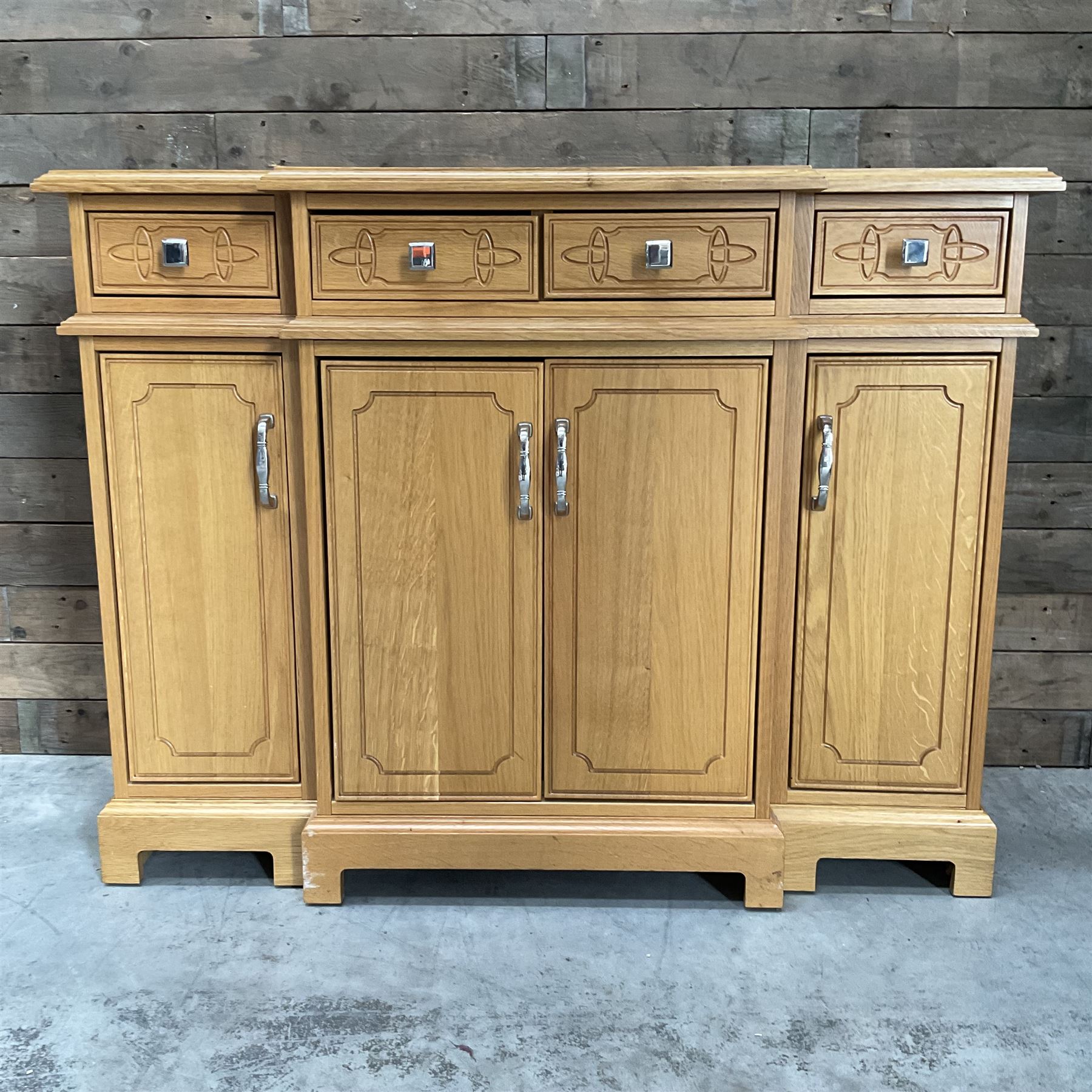 Light oak breakfront sideboard dresser, fitted with four drawers and four cupboards