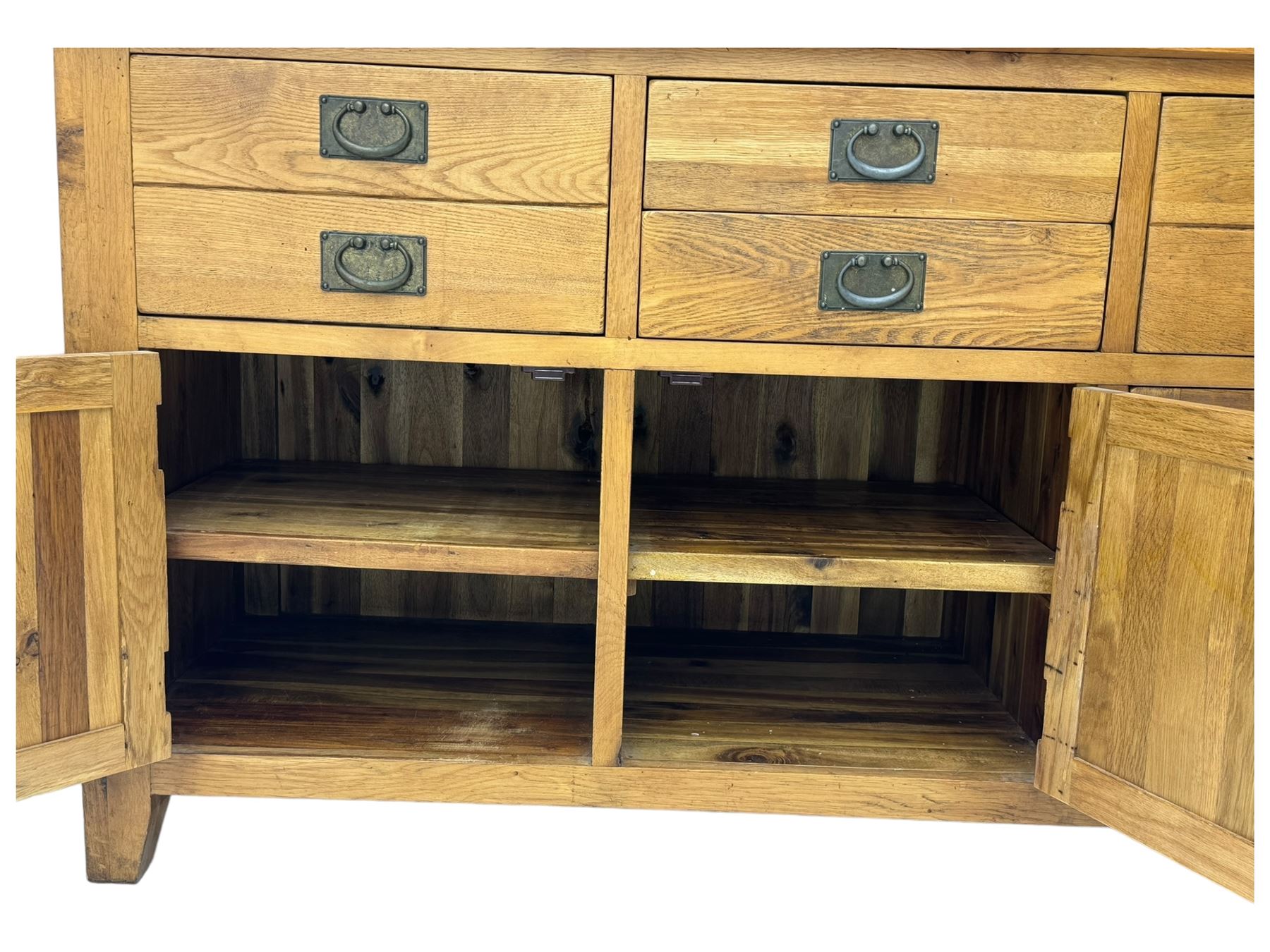 Oak dresser, upper section with twin glazed cupboard doors and central shelving with two trinket drawers, lower section fitted with six drawers over three panelled cupboard doors, raised on shaped feet 