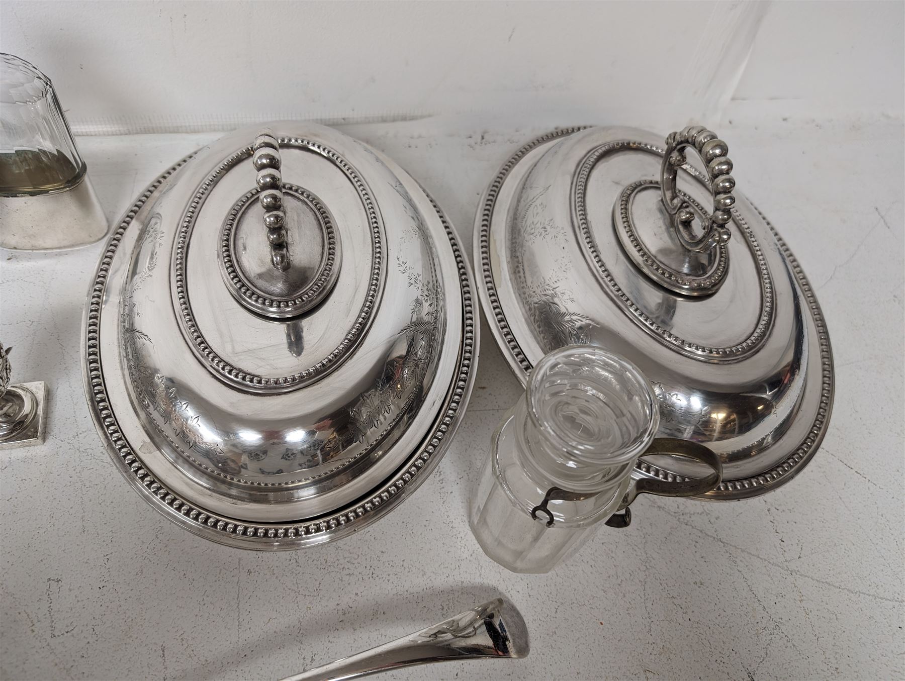 Glass hip flask, with silver cap/collar and plated cup and a silver topped pepper shaker, together with silver plated items including place mats, coasters, serving dishes, etc