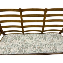 Ercol - mid-century three-piece ash lounge suite, featuring a three-seater sofa upholstered in a floral and woodland bird pattern (W197 x D95 x H99 cm), pair of matching armchairs with drop-in cushions (W88 x D90 x H98 cm).