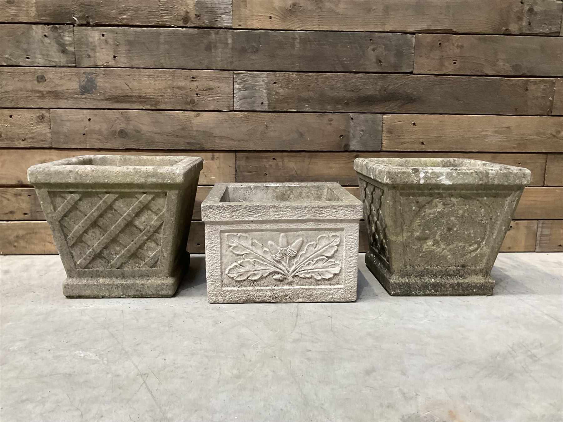 Pair of square cast stone planters, single planter with leaf decoration and a rectangular brick effect planter (4)