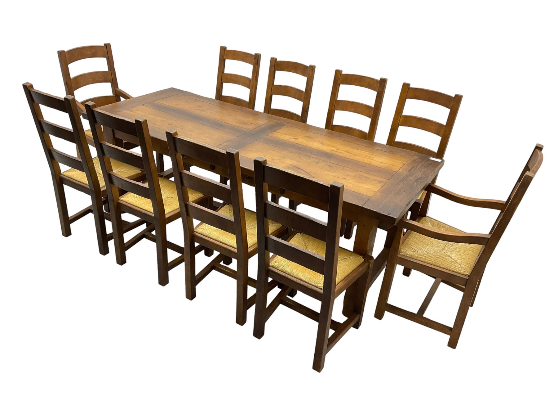 Antix Furniture - oak extending refectory dining table, rectangular plank top with two additional leaves and two drawers to the longer side, on square supports connected by H-stretcher; set of ten (8+2) ladder back dining chairs with rush seats