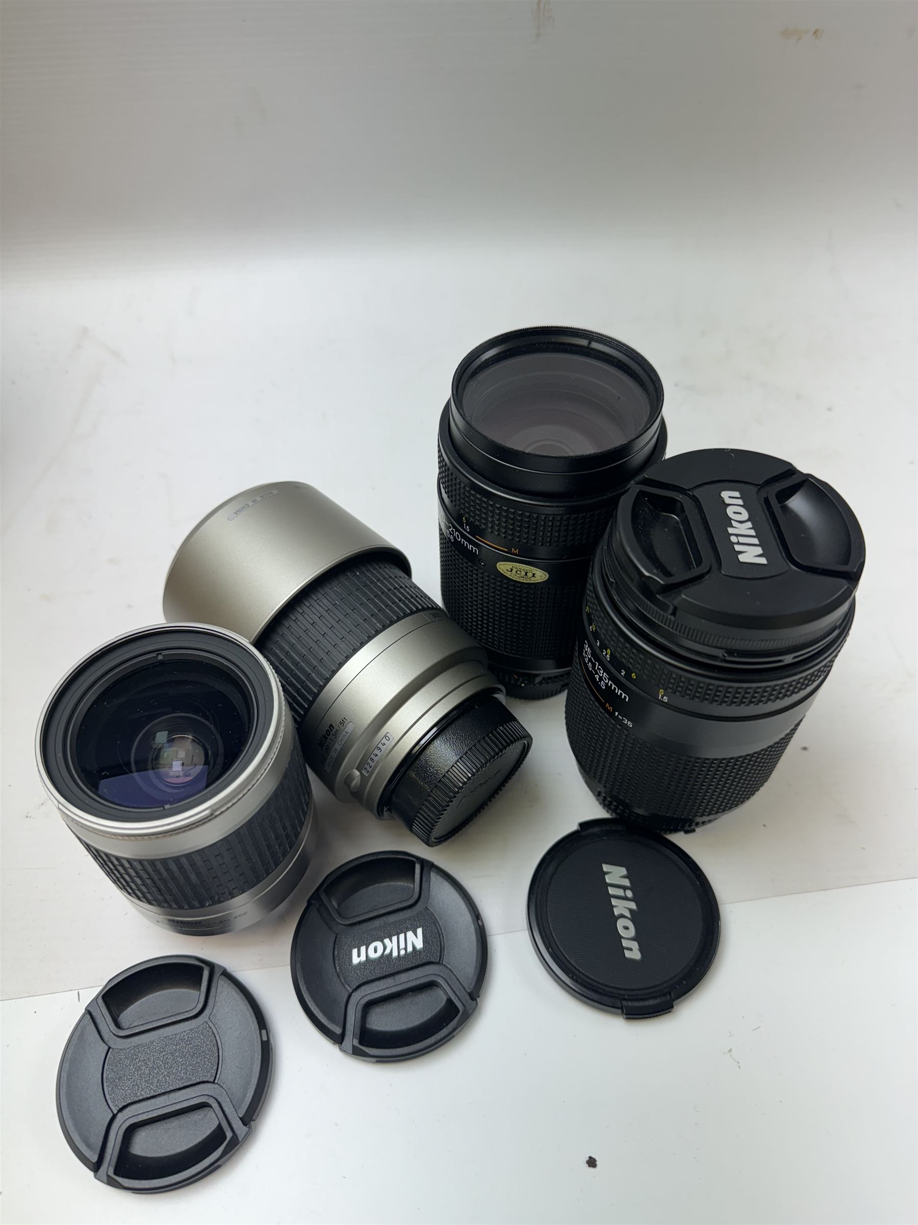 Four Nikon camera lenses, to include AF Nikkor 70-210mm 1:4-5.6 serial no. 2000640, AF Nikkor 70-300mm 1:4-5.6 G serial no. 2284940, AF Nikkor 35-135mm 1:3.5-4.5 serial no 301027 and AF Nikkor 28-100mm 1:3.5-5.6 G serial no 2185570