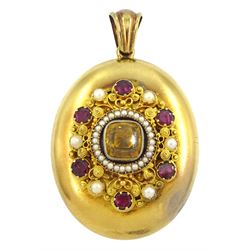 Victorian gold locket, the applied wirework decoration set with garnets, pearls and a paste yellow stone, with glazed reverse