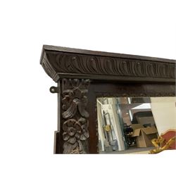 Victorian heavily carved oak wall mirror, projecting gadroon carved ovolo cornice, bevelled mirror plate within a lunette carved frame, decorated with applied fruit and foliage carved mounts, scroll carved brackets 