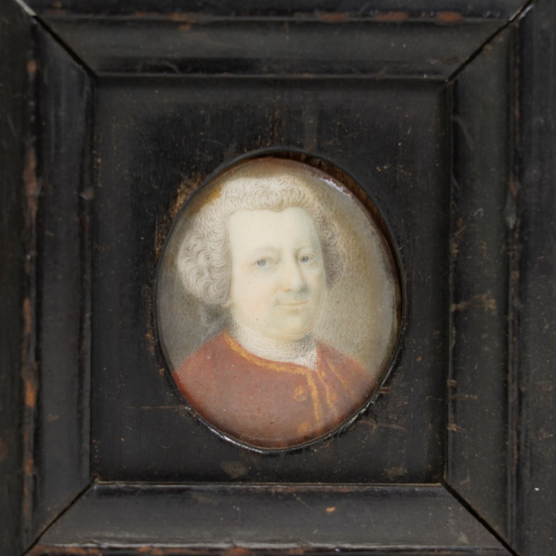 English School (18th century): Portrait of a Georgian Gentleman Wearing a White Wig and Red Jacket, miniature watercolour on ivory unsigned 3.5cm x 3cm. This item has been registered for sale under Section 10 of the APHA Ivory Act