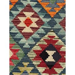 Maximana Kilim ground rug, the field decorated with a geometric pattern of multi-coloured diamonds and triangles, each containing stylised motifs, enclosed by a plain brown border